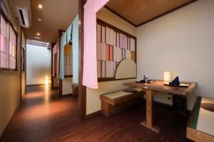 a room with a desk and stained glass windows at Onogawa Onsen Kajikaso in Yonezawa