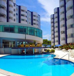 un grand bâtiment avec une grande piscine bleue dans l'établissement APARTAMENTO AGUAS DA SERRA 713 A, à Rio Quente