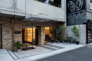 a exterior view of a building with a restaurant at Section L Hamamatsucho in Tokyo