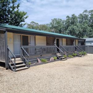 a mobile home with a porch and stairs to it at Alexandra Parklife Deluxe Studio 2 in Alexandra