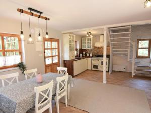a kitchen and dining room with a table and chairs at Large holiday villa with sauna, jacuzzi and pool in Perlino