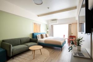 a living room with a couch and a bed at Section L Hamamatsucho in Tokyo