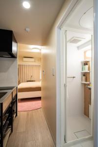 a room with a kitchen and a bedroom at Section L Hamamatsucho in Tokyo