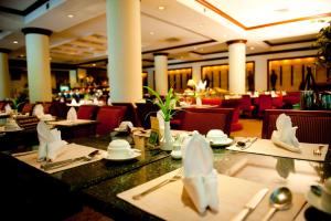 uma sala de jantar com mesas e cadeiras num restaurante em Wiang Inn Hotel em Chiang Rai