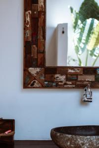 a bathroom with a mirror and a sink at Akasia Villas in Gili Islands