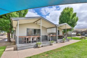 a house with a screened in porch with a table at BIG4 Mildura Getaway in Mildura