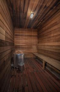 an empty wooden sauna with a grill and benches at All Seasons Motel Armidale in Armidale