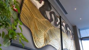 a painting of a peacock on the side of a building at Doanesia Premium Hotel & Spa in Tirana