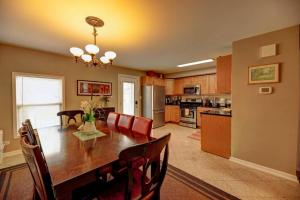 a kitchen and dining room with a table and chairs at Spacious Row Home next Transit near Downtown w Parking in Chicago
