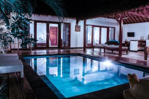 a swimming pool in a villa with a living room at Akasia Villas in Gili Islands