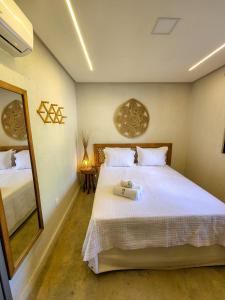 a bedroom with a bed with a suitcase on it at Kai Milagres Beach House in São Miguel dos Milagres +45 photos