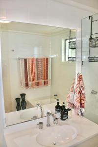 a bathroom with a sink and a mirror at The Byron Bay Guesthouse in Byron Bay