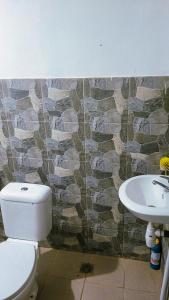 a bathroom with a toilet and a sink at Villa Bima Syandana Resort in Ciwidey