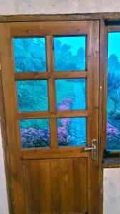uma porta de madeira com vista para o oceano em Villa Bima Syandana Resort em Ciwidey