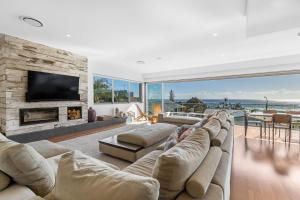 a living room with a couch and a fireplace at Daybreak at Currumbin in Gold Coast