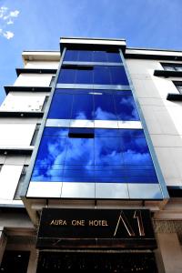 a building with a reflection of the sky in the windows at Aura One Hotel in Baguio