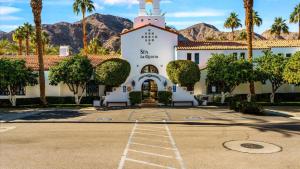 a building with a church with mountains in the background at SV006 Secluded Spa Villa Studio at LQ Resort in La Quinta