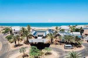 an aerial view of a resort with palm trees and the ocean at Mantarays Ningaloo Beach Resort in Exmouth