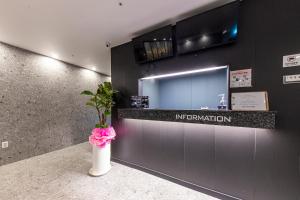 a bathroom with a counter with a vase with a flower at Wall Hotel in Cheonan