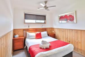 a bedroom with a bed with a red blanket at BIG4 Mildura Getaway in Mildura