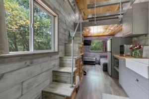 an interior view of a tiny house with wood paneling at Stunning Modern Tiny Home with Grill in Fredericksburg