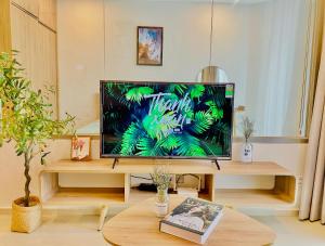 a flat screen tv sitting on top of a wooden table at The Song Vung Tau Apartment in Vung Tau