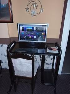 
a laptop computer sitting on top of a wooden desk at Garni Hotel Lav in Belgrade
