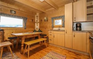 a kitchen with a table and a sink in a cabin at Amazing Home In Preitenegg With Wifi And 1 Bedrooms in Unterauerling