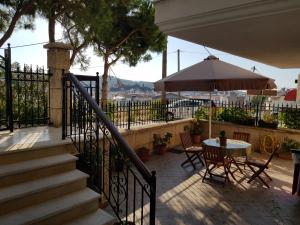 a patio with a table and an umbrella at Filidas Apartments in Skiathos
