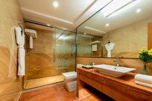 a bathroom with a sink and a shower and a toilet at Hampton by Hilton Zhuhai Gongbei Port in Zhuhai