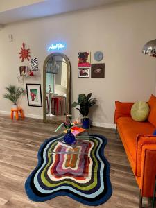 a living room with a couch and a colorful rug at Jack London square stylish luxury 1BD apartment in Oakland