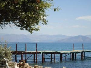 a dock in the water next to the ocean at Kouros apartment, Agios Nikolaos, Petriti in Ágios Nikólaos