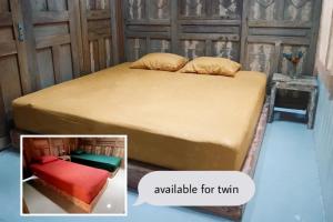 a bed in a room with at Omah Bagelen Homestay 