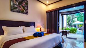 Ένα ή περισσότερα κρεβάτια σε δωμάτιο στο Pondok Baruna Frangipani