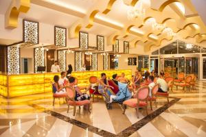 a group of people sitting in chairs in a lobby at Concordia Celes Beach Hotel in Okurcalar