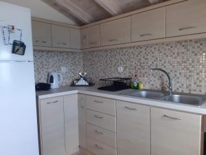 a kitchen with white cabinets and a sink at kedros in Elafonisos