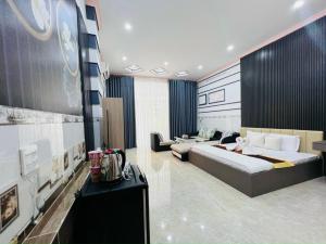 a bedroom with a large bed and a couch at Đại Quang Hotel in Can Tho