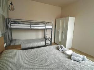 a bedroom with two bunk beds and towels on the floor at Studio Thermi 1 in Varna City