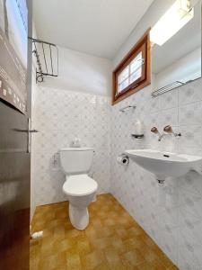 a bathroom with a toilet and a sink at Chalet Albarose - Vercorin in Vercorin