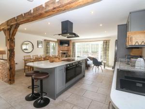 a kitchen with a large island with a counter top at Y Stabl The Stable in Oswestry