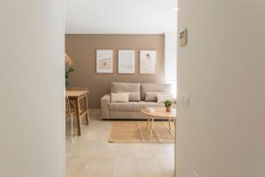 a living room with a couch and a table at Beach & Port in Gand&iacute;a