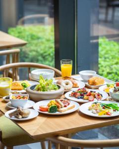 a wooden table with plates of food on it at Crowne Plaza Foshan Nanhai - an IHG Hotel in Guangzhou