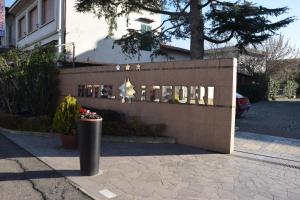 a sign for a hotel with a trash can at Hotel I Cedri in Scandicci