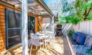 a patio with a dining table and chairs on a patio at Peppi Lane Stay in Margaret River Town