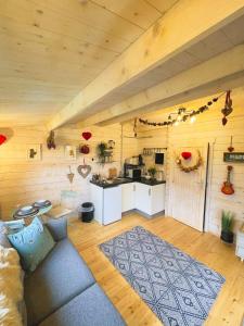 a living room with a couch and a kitchen at The Gallows in Pembroke