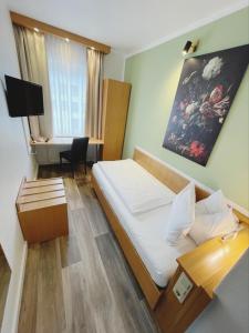 una camera d'albergo con letto e scrivania di Europa Hotel City a Saarbrücken