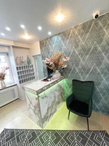 a bathroom with a counter and a chair at Europa Hotel City in Saarbrücken