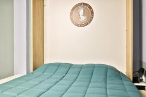 a blue bed in a room with a sign on the wall at Apollo 4 - Luxury Apartment (City Center Studio) in Katerini