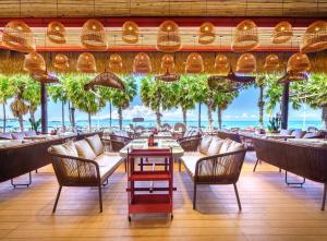 a restaurant with a view of the ocean at A-One New Wing Hotel in Pattaya