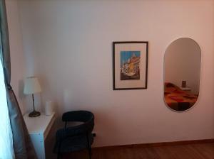 蒙塔日的住宿－Appartement d'une chambre avec vue sur le lac et wifi a Montargis，一间设有镜子、一张床和椅子的房间